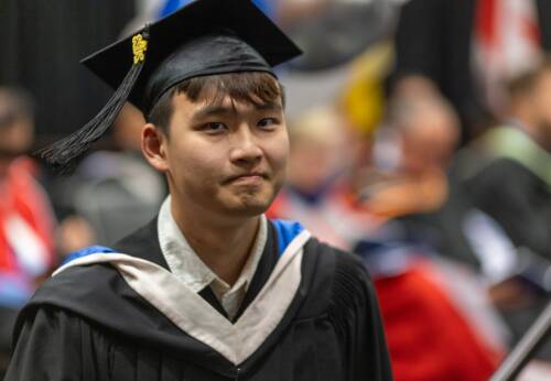 Student in cap and gown at graduation