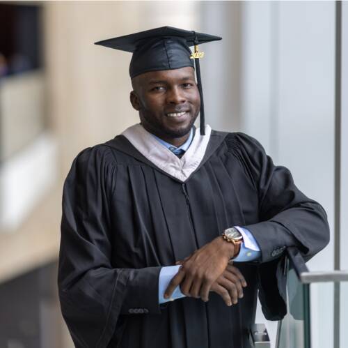 Graduate posing in gown